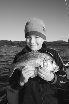 Tom Griffiths, 9, with his first bream on a lure.
